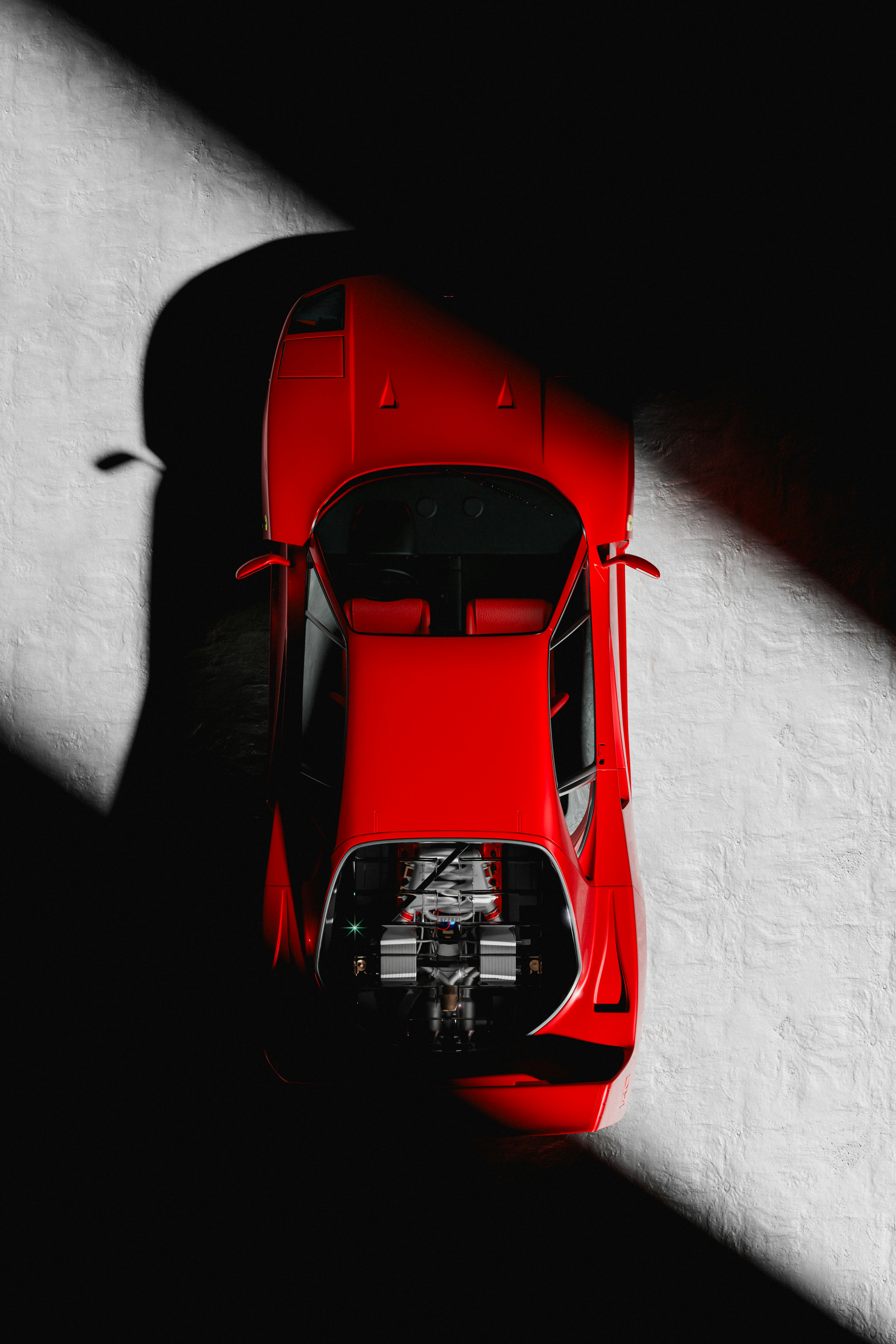 Red Ferrari photographed from above with dramatic lighting